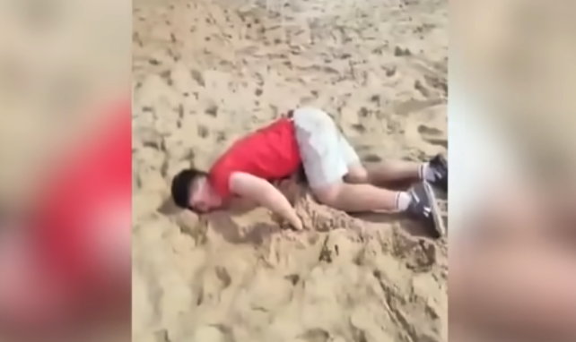 Lifeguard and bystanders assist a tourist lying on the sand at Ipanema Beach, Rio de Janeiro, after a reported drink-spiking incident.